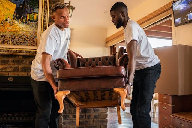 Two men carrying a sofa