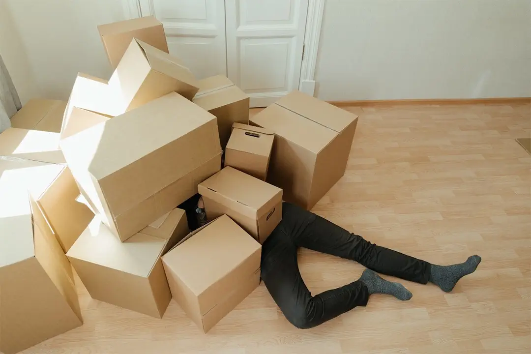 a man is completely covered by moving boxes - avoid a diy move