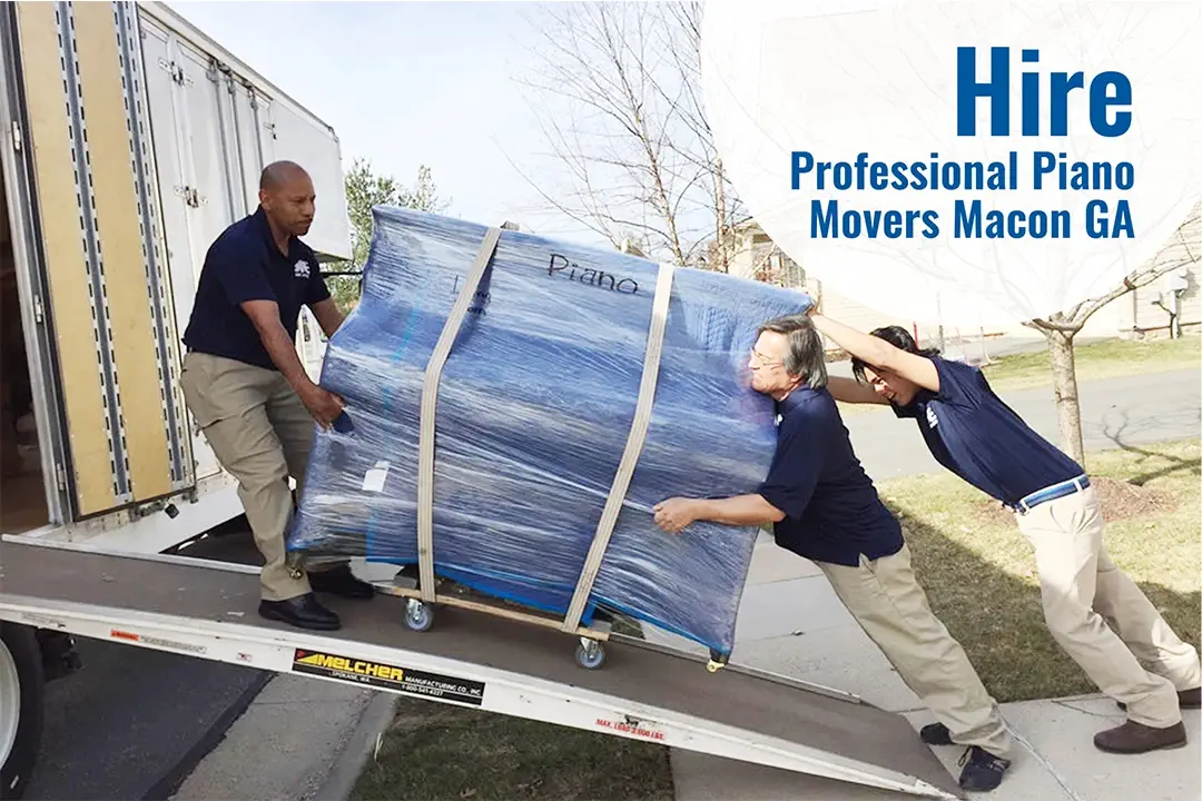 two professional piano movers are pushing the piano while one is pulling it in the truck